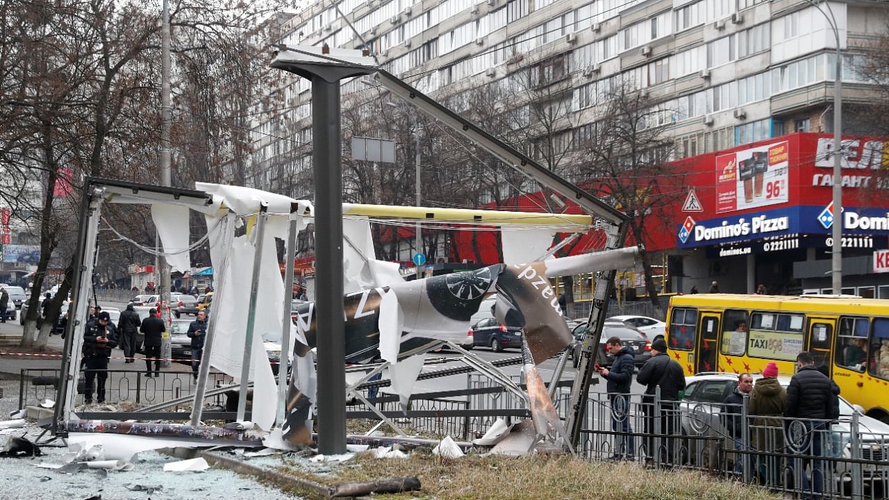 Debris and rubble are seen at the site where a missile landed in the street, in Kyiv. Credit: Reuters Photo