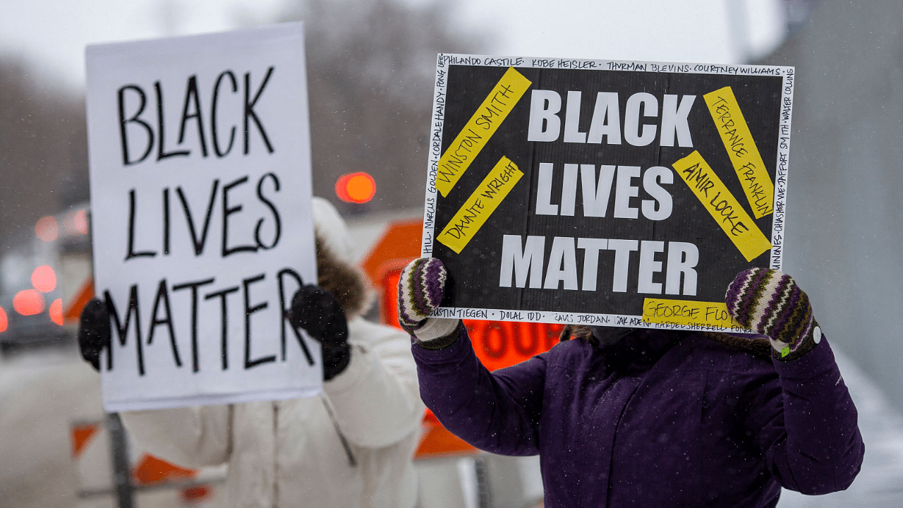 Demonstrators hold 'Black Lives Matter' signs in front of the US District Court in St Paul, Minnesota. Credit: AFP Photo