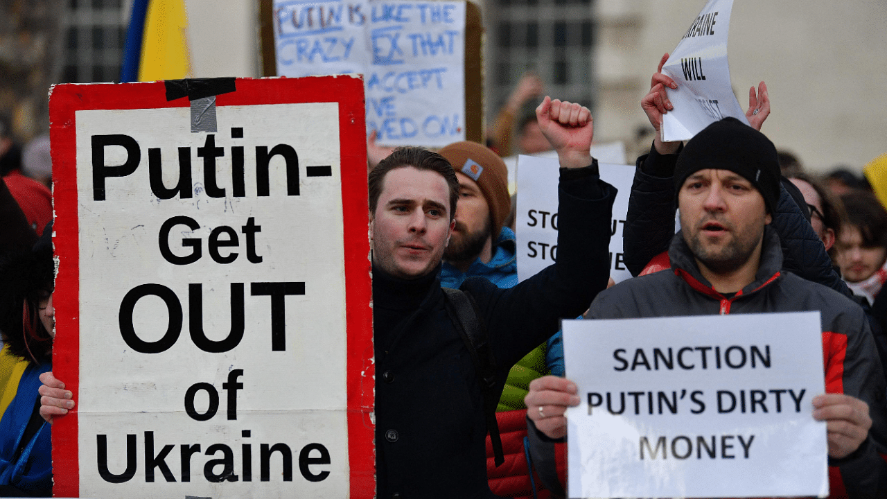 People stand with placards at a demonstration staged in front of the Downing Street gates, in central London, on February 24, 2022 to protest against Russia's invasion of Ukraine. Credit: AFP Photo