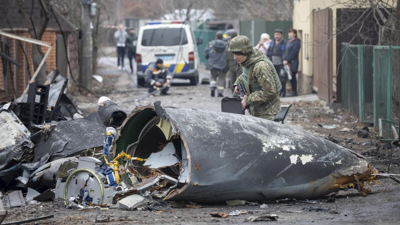 A Ukrainian Army soldier inspects fragments of a downed aircraft in Kyiv. Credit: AP/PTI file photo