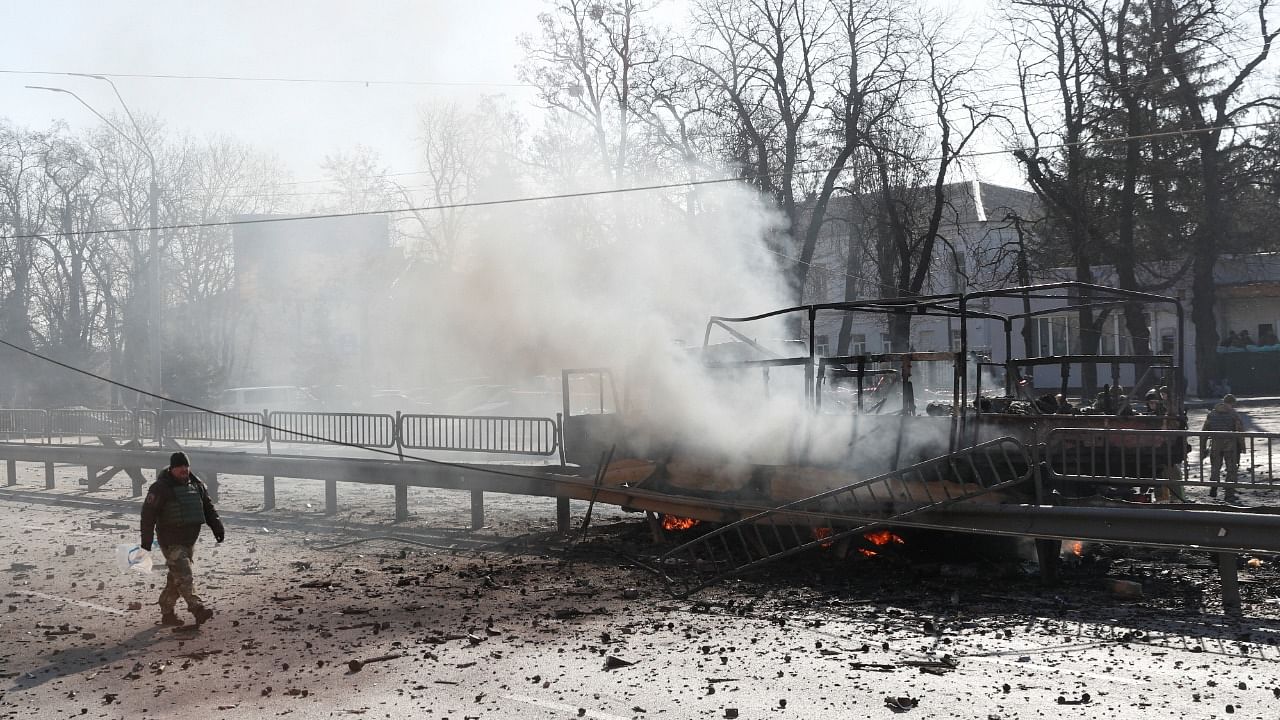 A Ukrainian serviceman walks by a damaged vehicle, at the site of a fighting with Russian troops after Russia launched a massive military operation against Ukraine, in Kyiv. Credit: Reuters File Photo