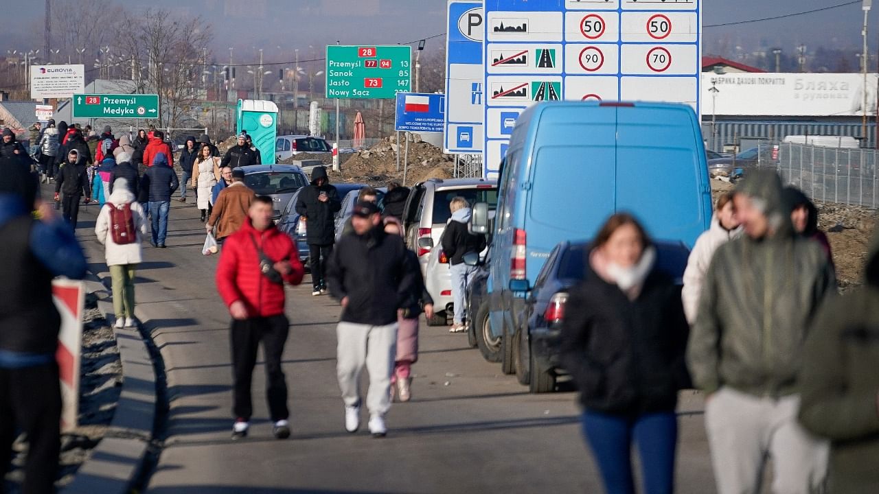 People flee Russian invasion in Ukraine by crossing Polish border. Credit: Reuters Photo