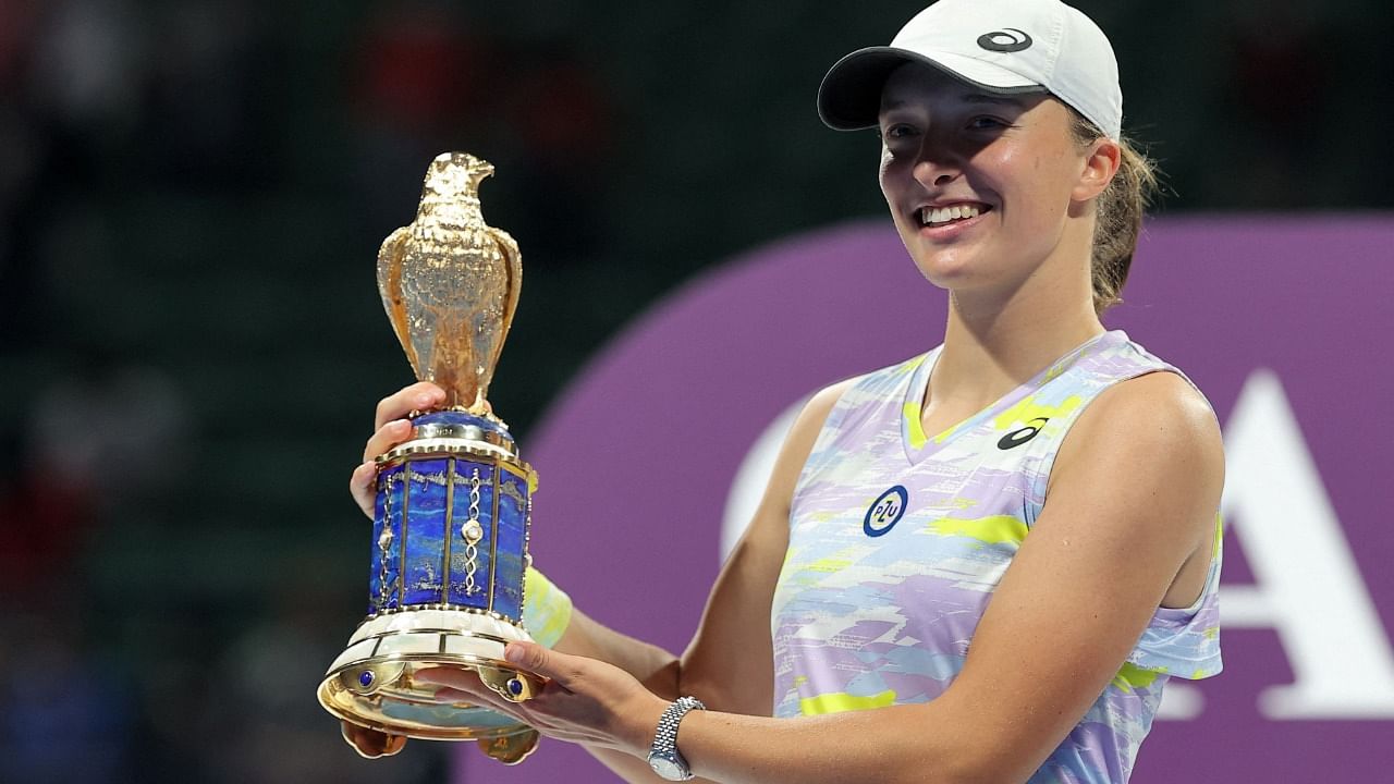 Iga Swiatek of Poland poses with the winner's trophy after winning the final match of the 2022 WTA Qatar Open in Doha on February 26, 2022. Credit: AFP Photo