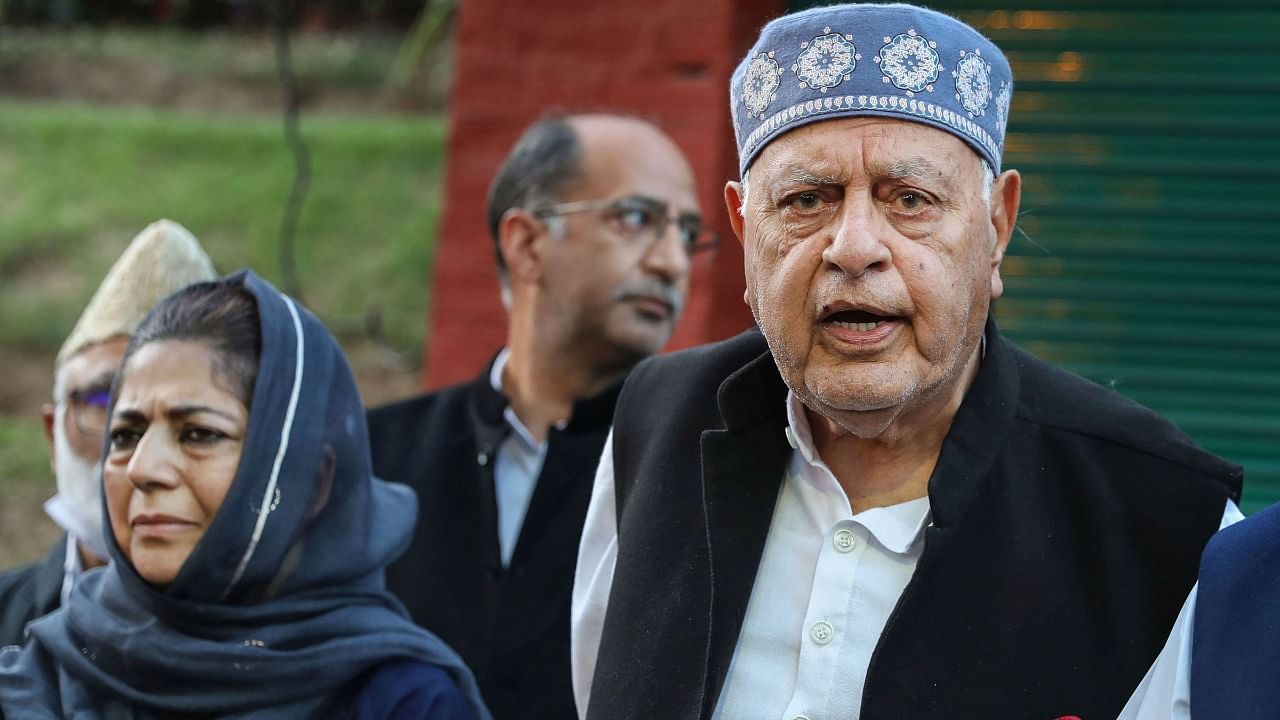 Jammu and Kashmir National Conference President Farooq Abdullah addresses a press conference as Peoples Democratic Party (PDP) President Mehbooba Mufti looks on after meeting of signatories to the Gupkar declaration, at his residence in Srinagar. Credit: PTI File Photo