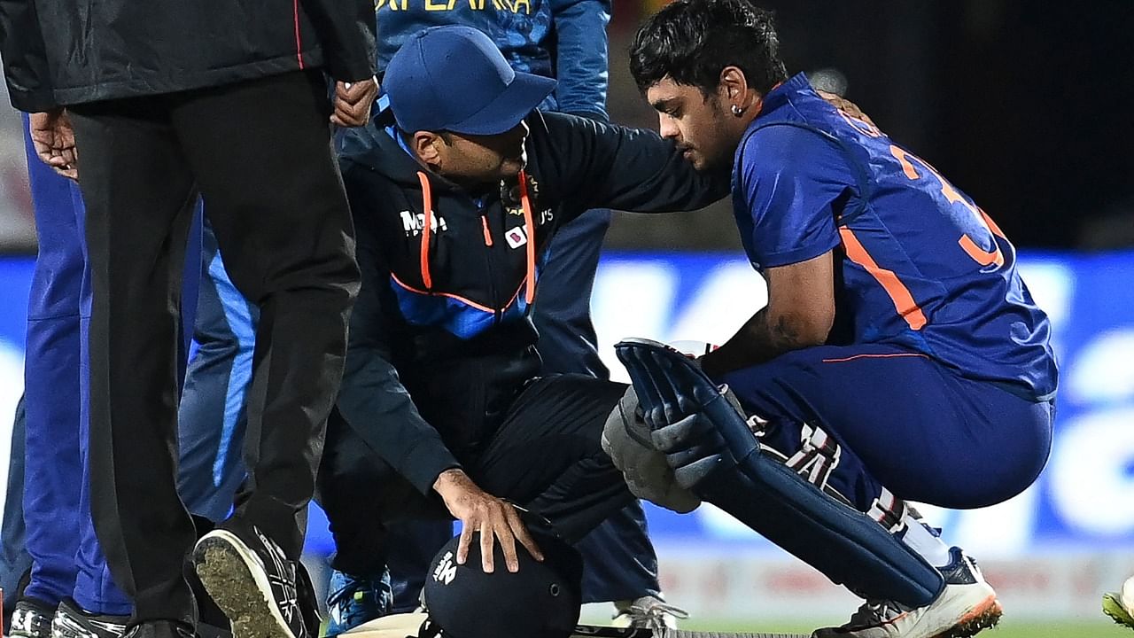 India's Ishan Kishan (R) is checked by medical staff after being hit by a bouncer during the second T20 international cricket match between India and Sri Lanka. Credit: AFP Photo