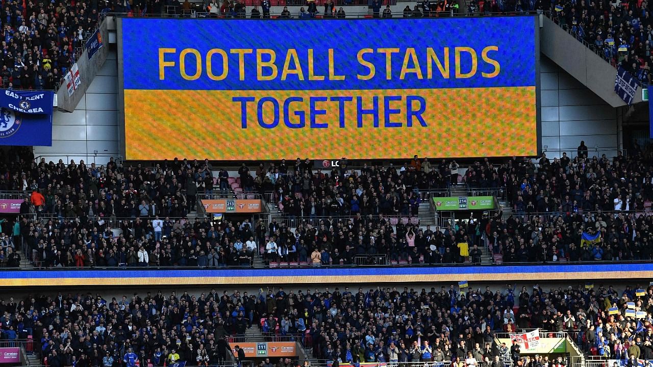 A 'Football Stands Together' message is displayed in Ukrainian colours above the crowd ahead of the English League Cup final. Credit: AFP Photo