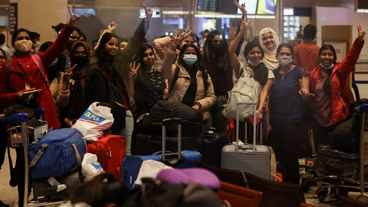 Students react after landing at the Chhatrapati Shivaji Maharaj International Airport after a special Air India flight carrying stranded Indian citizens from Ukraine landed in Mumbai. Credit: Reuters Photo