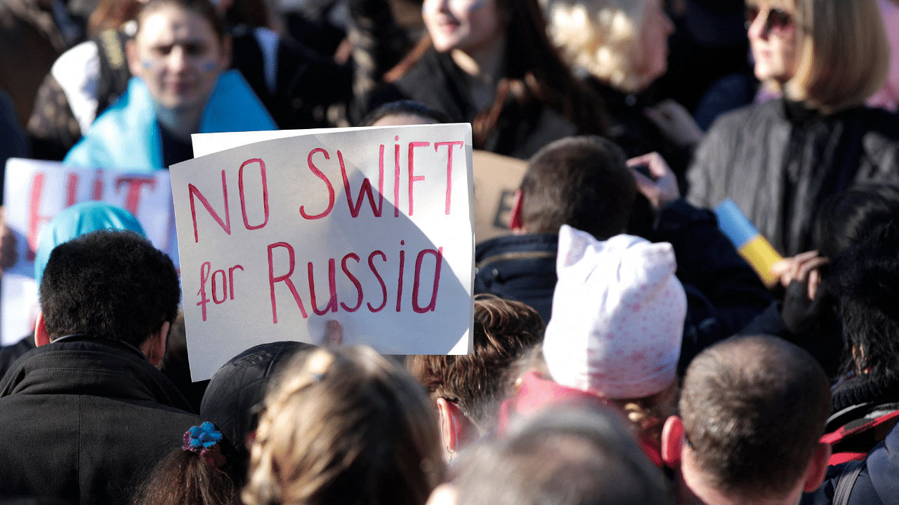 A protester holds a placard during a rally against Russia's invasion of Ukraine, at Place de la Republique in Paris. Credit: AFP Photo