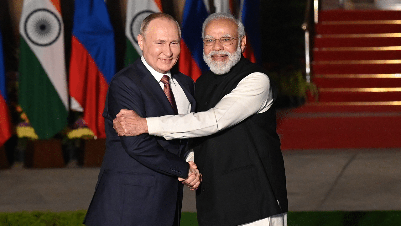 India's Prime Minister Narendra Modi (R) greets Russian President Vladimir Putin. Credit: AFP Photo