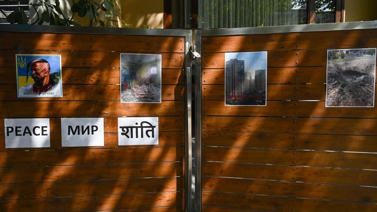 Posters depicting conflict damage are pasted on the main gate of the embassy of Ukraine in New Delhi. Credit: AFP Photo