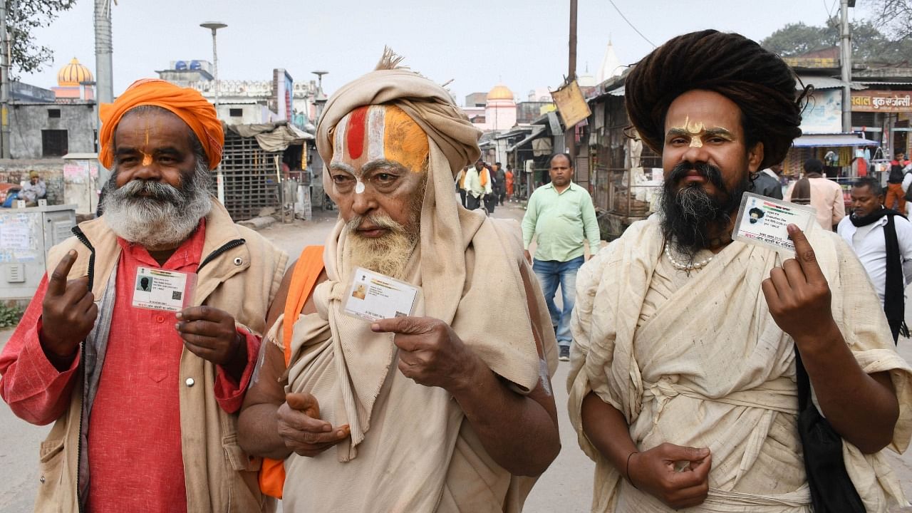  Hindu saints show their identification cards after casting their votes, during the fifth phase of the Uttar Pradesh Assembly elections, in Ayodhya. Credit: PTI File Photo