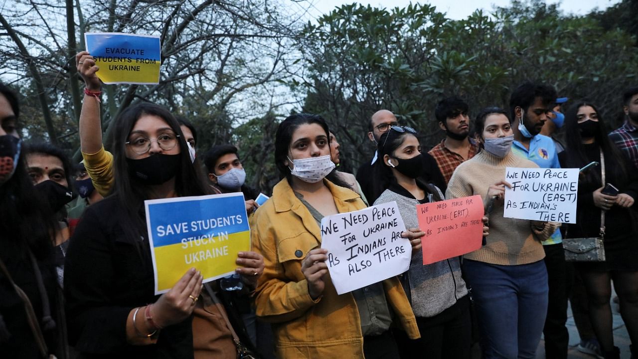 Family and friends of Indian students stuck in Ukraine hold placards, as they demand the Indian Government to evacuate the stranded students, near the Russian embassy in New Delhi. Credit: Reuters photo