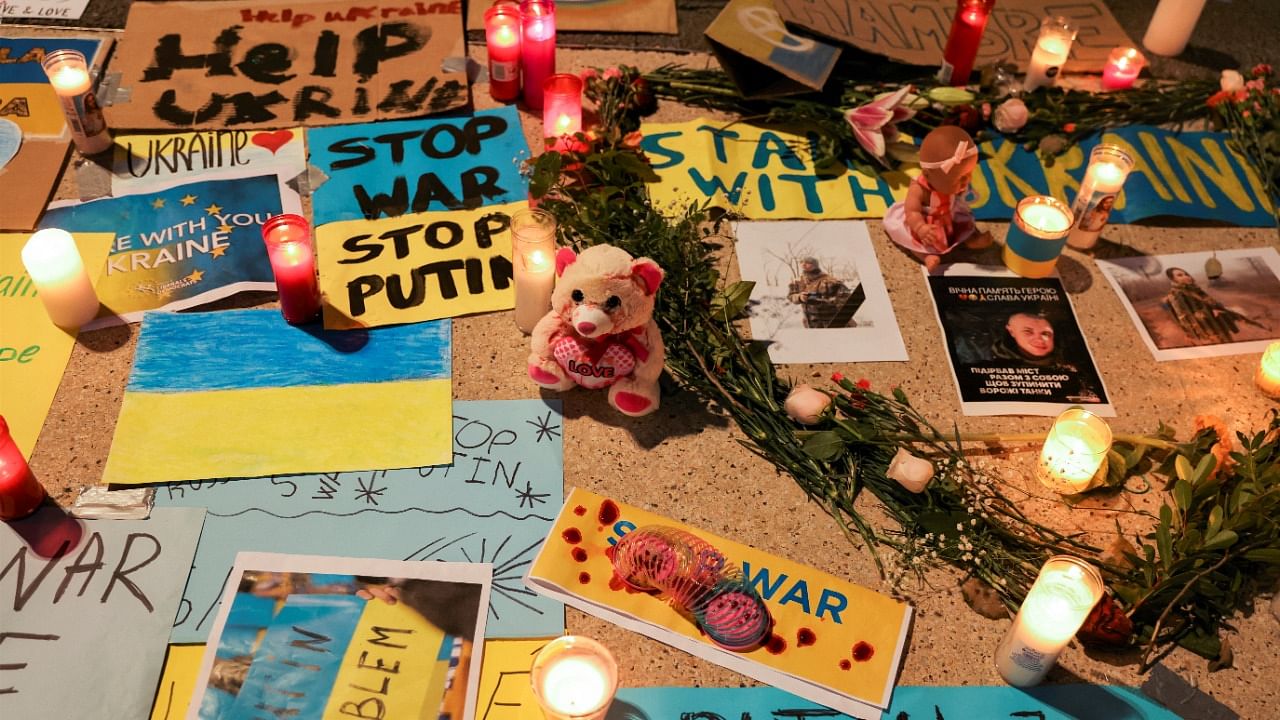 Placards and candles are seen during an anti-war protest, after Russia launched a massive military operation against Ukraine, in Barcelona, Spain, February 27, 2022. Credit: Reuters Photo