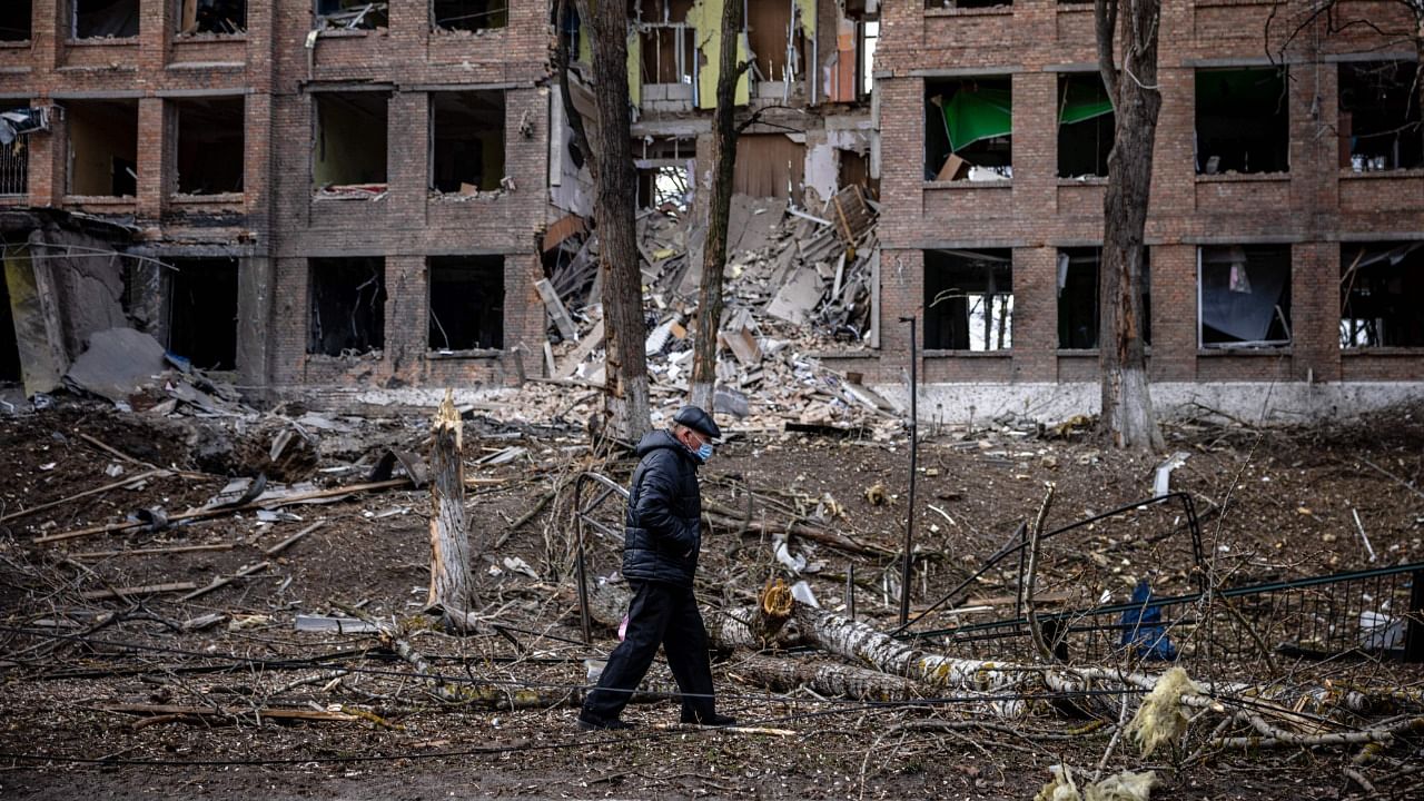 A man walks in front of a destroyed building after a Russian missile attack in the town of Vasylkiv, near Kyiv. Credit: AFP Photo