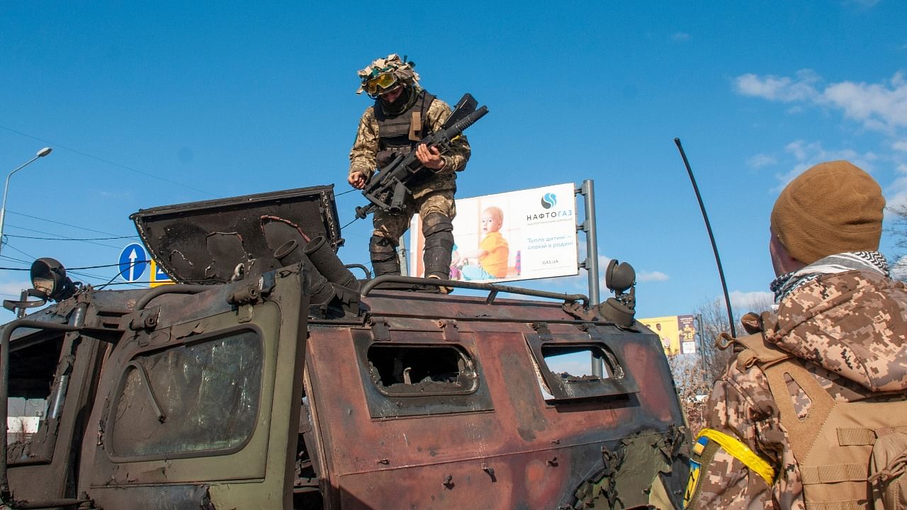 Ukrainian soldiers inspects a damaged military vehicle after fighting in Kharkiv, Ukraine. Credit: AP/PTI Photo