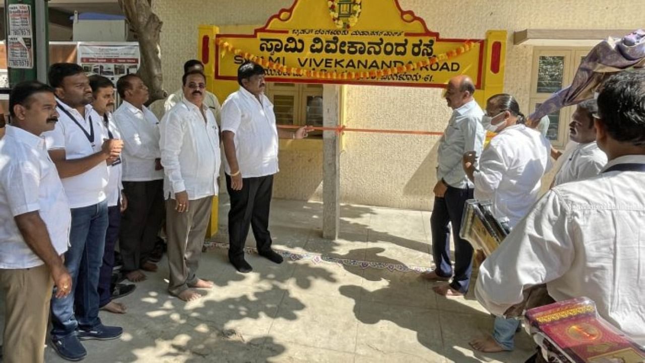 Uttarahalli Ward former corporator Hanumanthaiah, along with residents, inaugurates a road named after Swamy Vivekananda at Muniraju Layout, Gubbalala, in Bengaluru on Sunday, February 27, 2022. Credit: DH Photo/Pushkar V