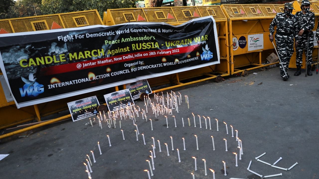 Candles are lit in the shape of the peace symbol to show solidarity with Ukraine, next to a police barricade at Jantar Mantar, in New Delhi. Credit: Reuters Photo