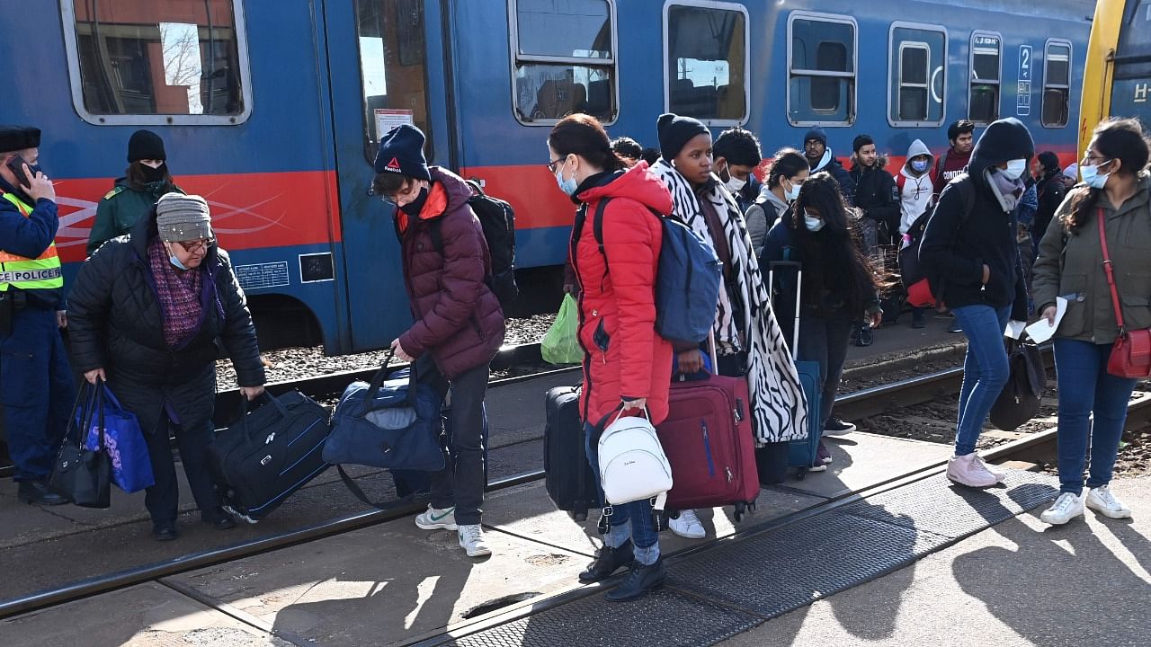 Refugees arriving from Ukraine including African and Indian students of Kyiv University get off a train at the railway station in the Hungarian-Ukrainian border town of Zahony. Credit: AFP Photo