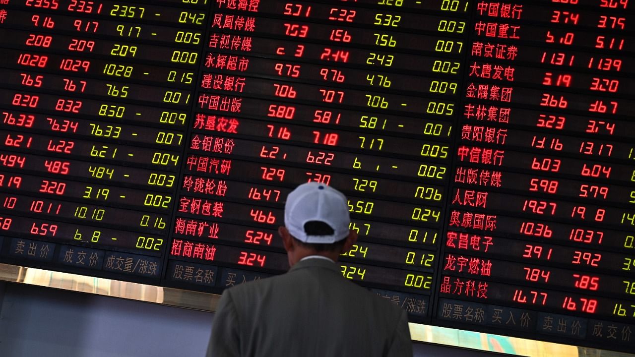 Investors monitor stock price movements at a securities company in Shanghai. Credit: AFP Photo