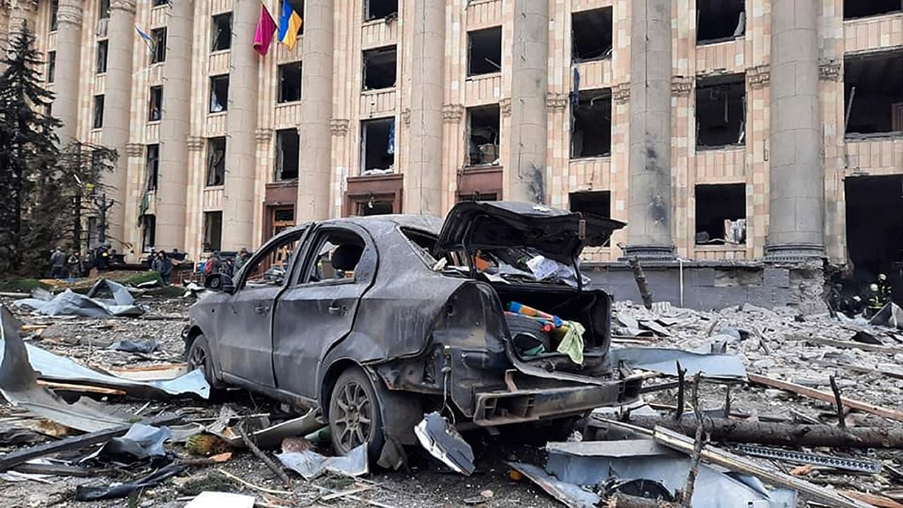 A burnt car is seen in front of a damaged City Hall building, in Kharkiv, Ukraine. Credit: AP Photo