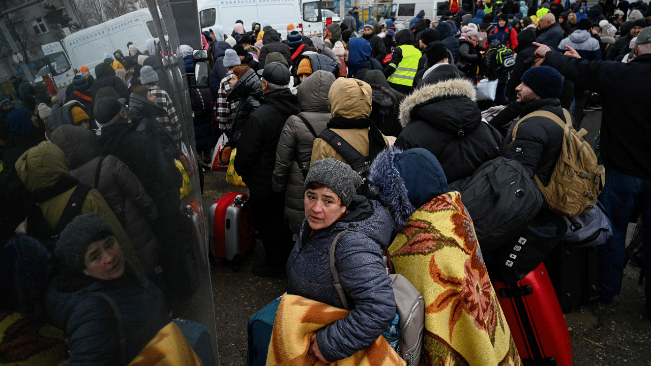 Refugees from Ukraine wait to enter a bus at the Moldova-Ukrainian border's checkpoint near the town of Palanca. Credit: AFP Photo
