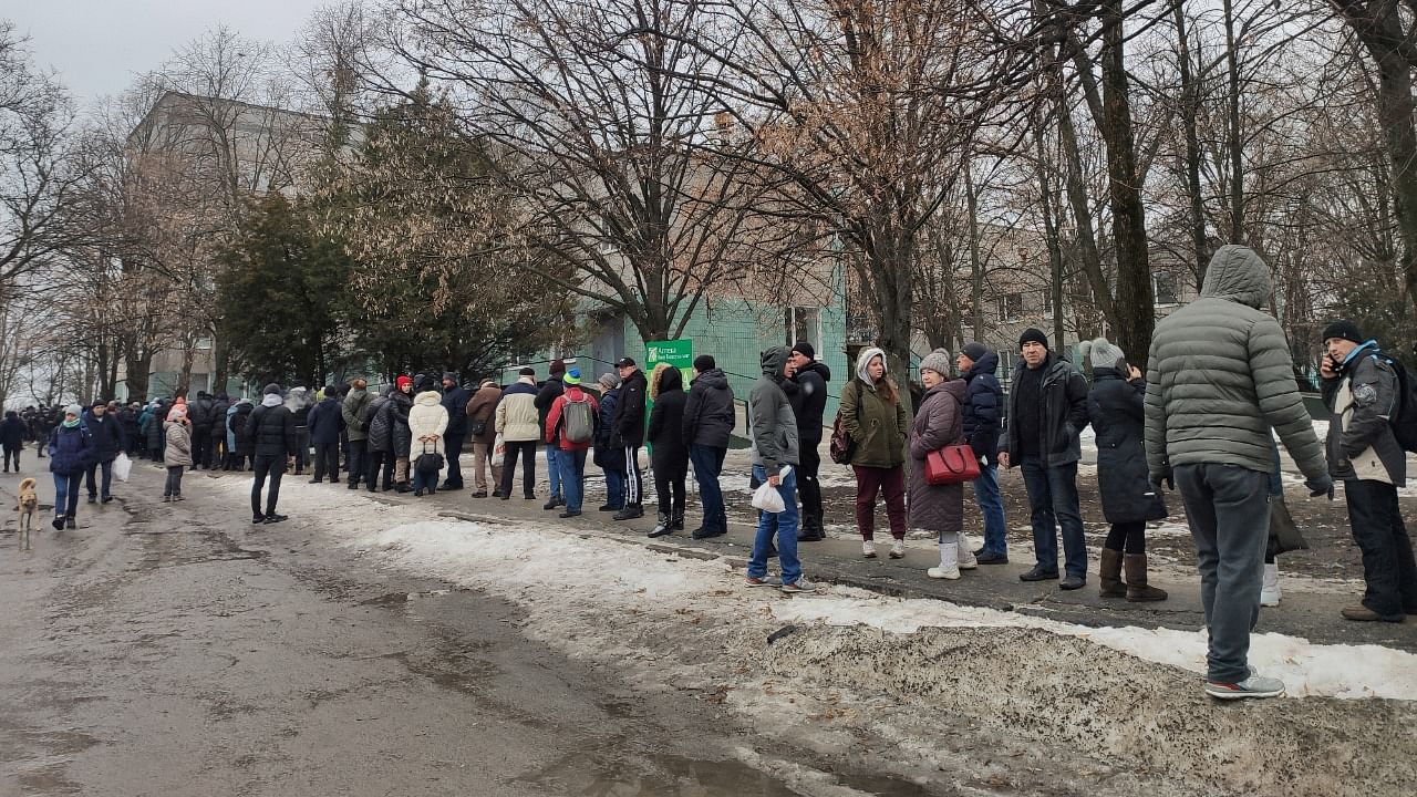 Local residents queue to receive food at the territory of a hospital, as Russia's invasion of Ukraine continues, in Kharkiv. Credit: Reuters Photo