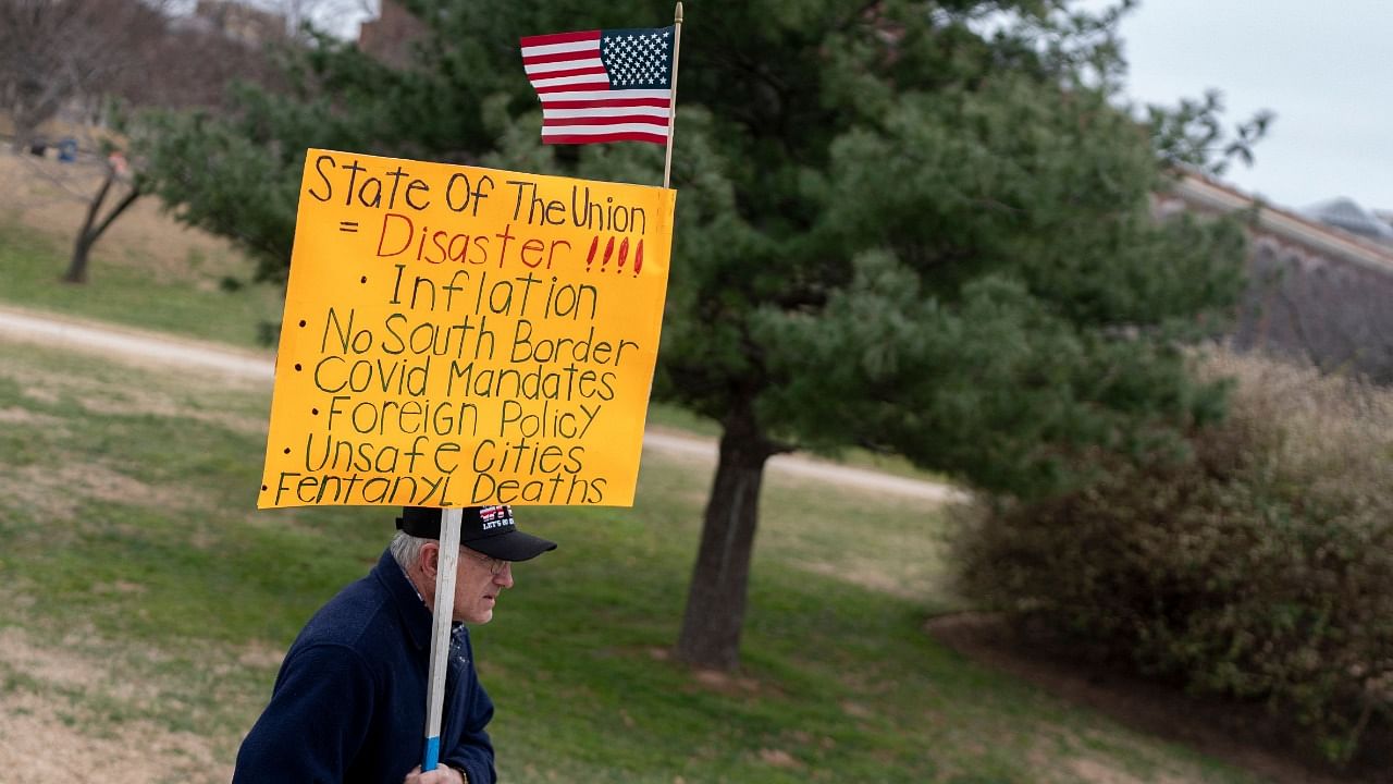 A demonstrator carries a protest sign in Washington, DC, on March 1, 2022, ahead of US President Joe Biden's State of the Union address. Credit: AFP Photo