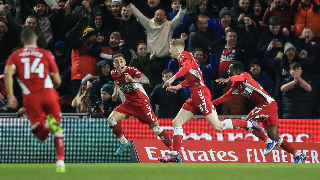 Middlesbrough's English striker Josh Coburn (C) celebrates with teammates after scoring. Credit: AFP Photo