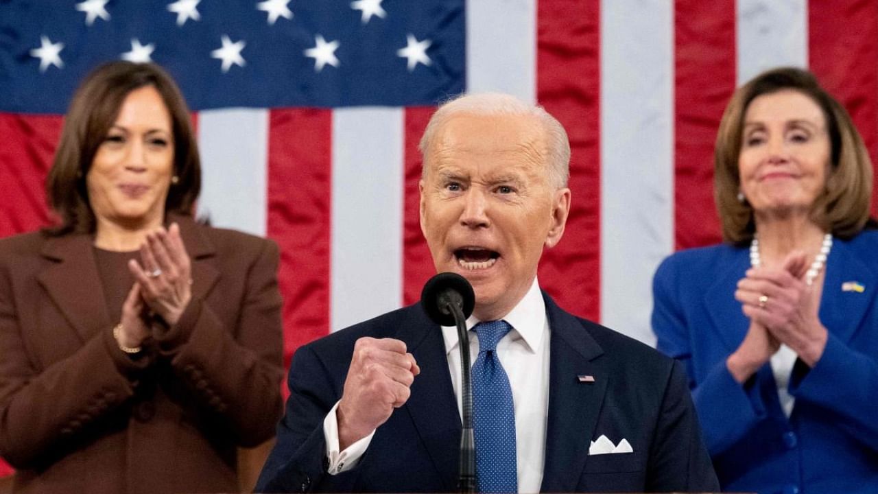 US President Joe Biden gestures, applauded by US Vice President Kamala Harris (L) and US House Speaker Nancy Pelosi (D-CA), as he delivers his first State of the Union address at the US Capitol. Credit: AFP Photo