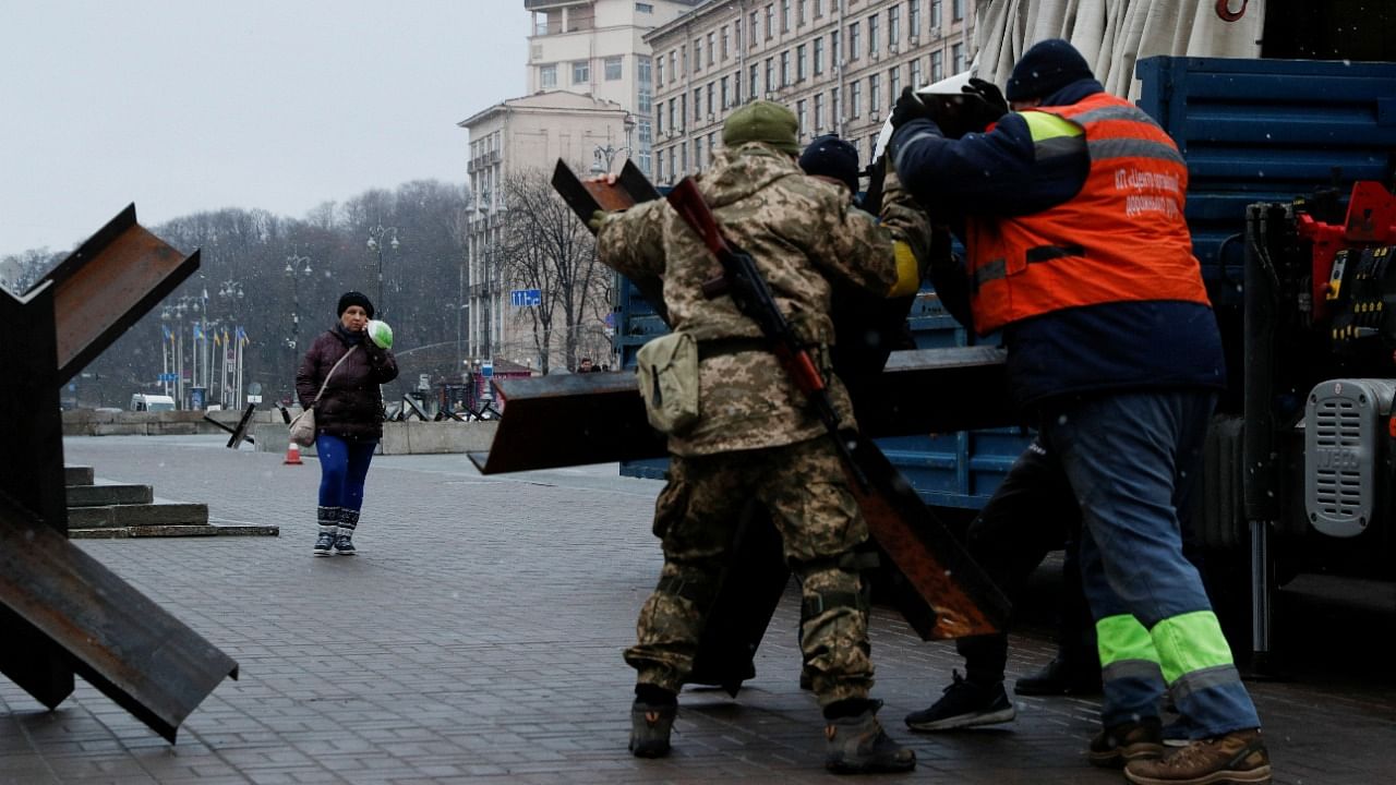 Members of the Territorial Defence Forces and volunteers place anti-tank obstacles at a checkpoint at the Independence Square in central Kyiv. Credit: Reuters File Photo