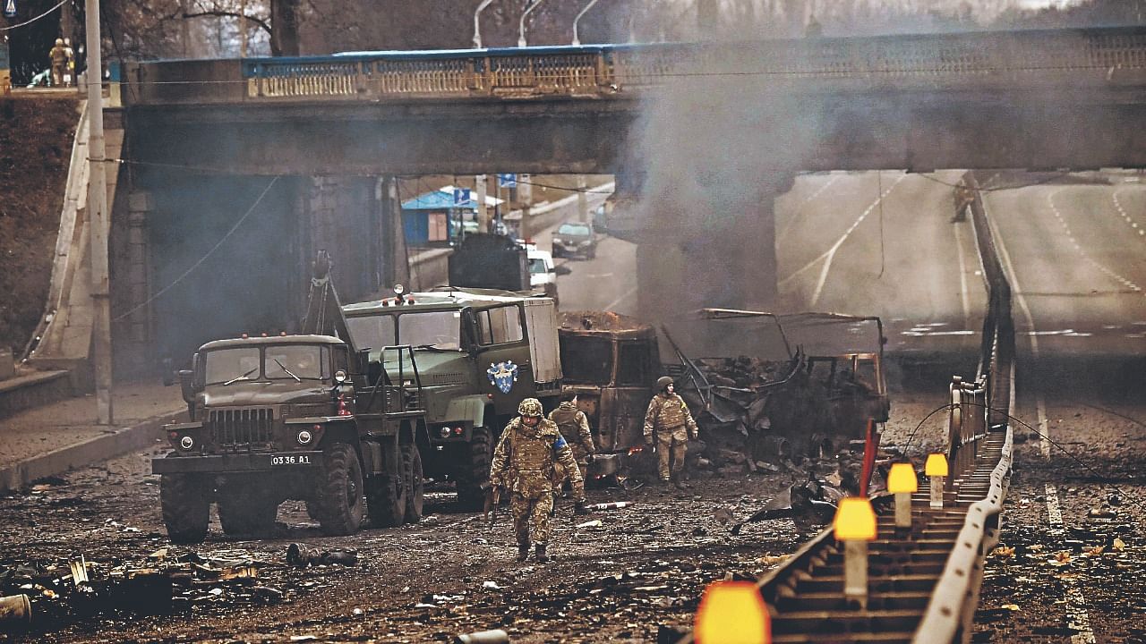 Ukrainian service members are seen at the site of a fighting with Russian raiding group in the Ukrainian capital of Kyiv in the morning of February 26, 2022, according to Ukrainian service personnel at the scene. Credit: AFP Photo