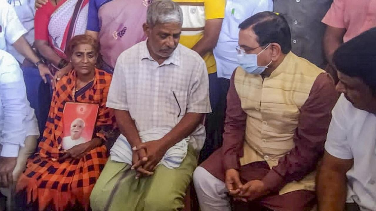 Union Minister of Parliamentary Affairs Prahlad Joshi meets Shekharappa Gyanagoudar, father of Naveen Shekharappa, a final year medical student, who passed away due to Russian shelling in the Ukrainian city of Kharkiv, at Chalageri village, in Haveri, Wednesday, March 2, 2022. Credit: PTI Photo