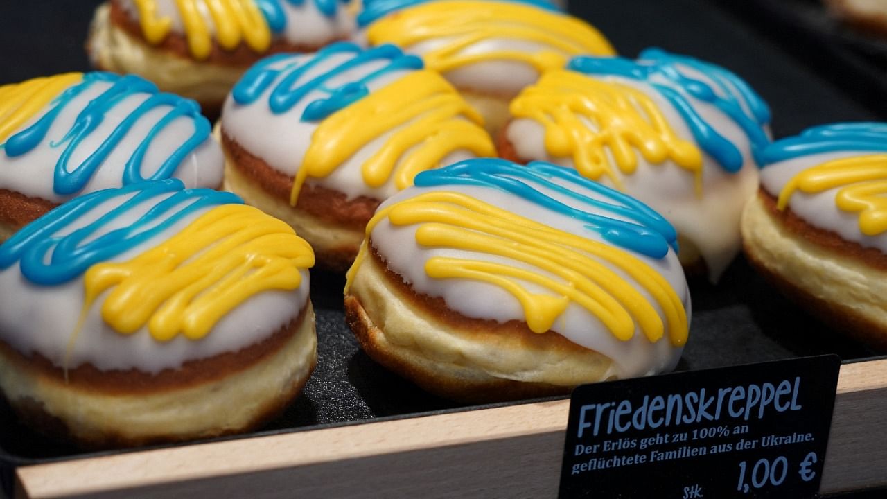 German donut pastry, also called Pfannkuchen or Berliner, is decorated in Ukrainian national colours to collect money for donation. Credit: Reuters Photo