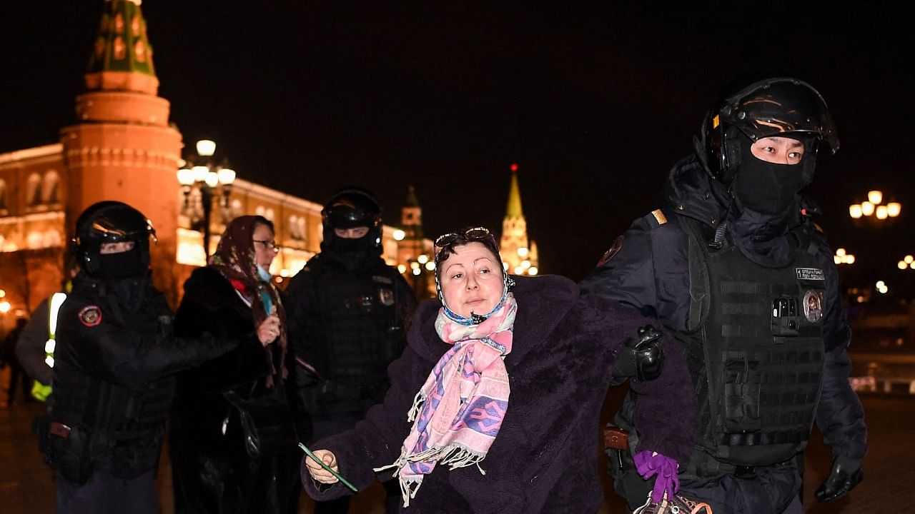 Police officers detain a woman during a protest against Russia's invasion of Ukraine in central Moscow on March 3, 2022. Credit: AFP Photo