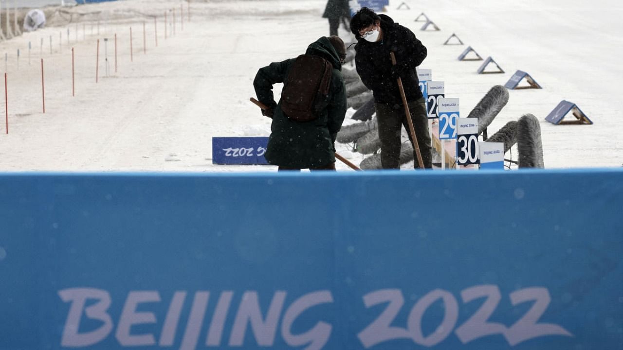 Officials check the conditions at the shooting range of the National Biathlon Centre during bad weather ahead of the Beijing 2022 Winter Paralympic Games. Credit: Reuters Photo