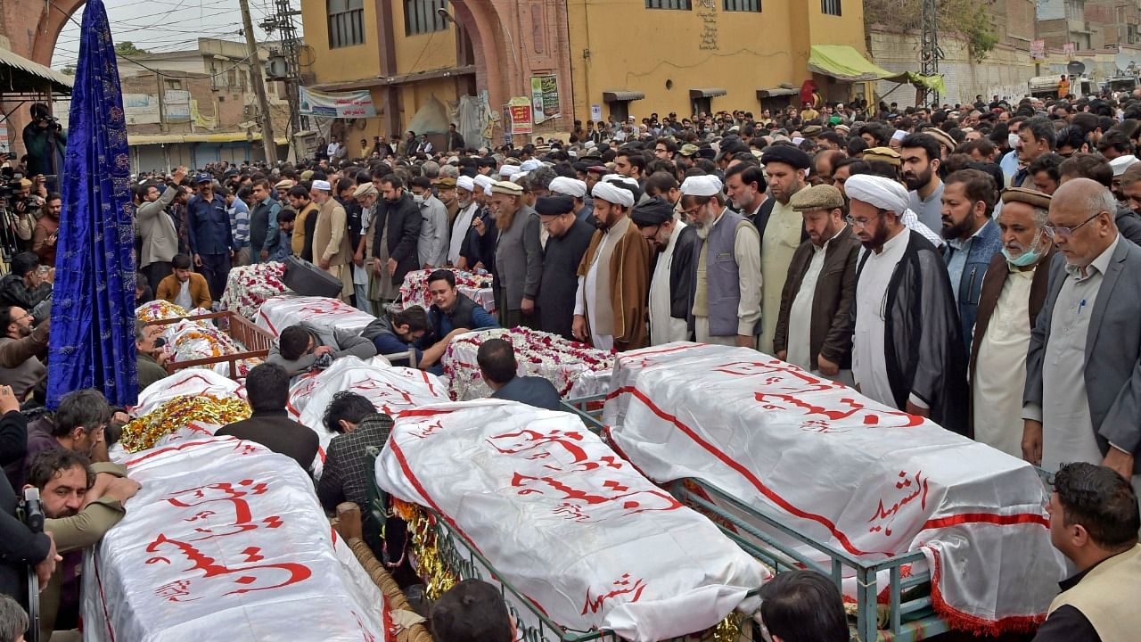 Mourners offer funeral prayers for bomb blast victims a day after a suicide attack at a Shiite mosque in Peshawar. Credit: AFP Photo