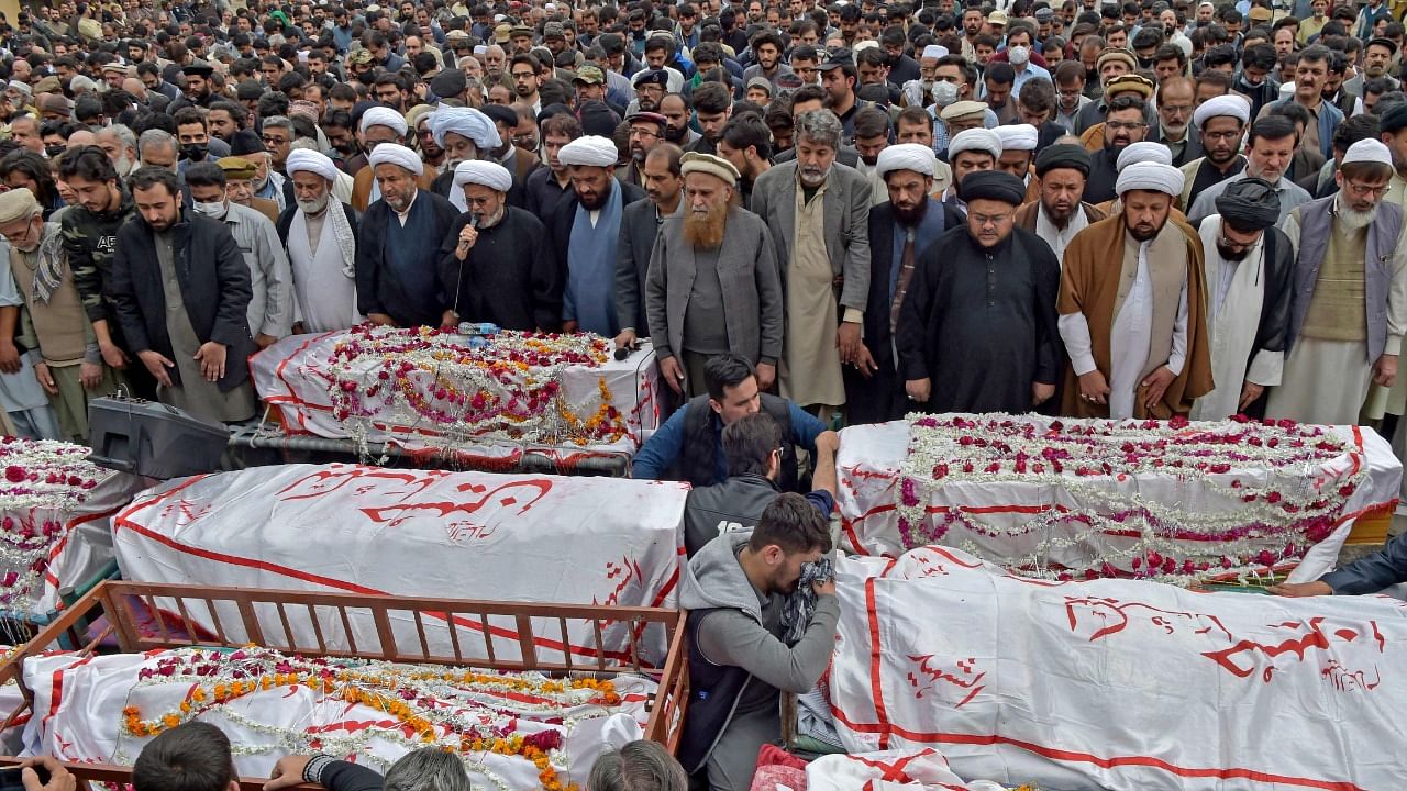 Mourners offer funeral prayers for bomb blast victims a day after a suicide attack at a Shiite mosque in Peshawar. Credit: AFP Photo