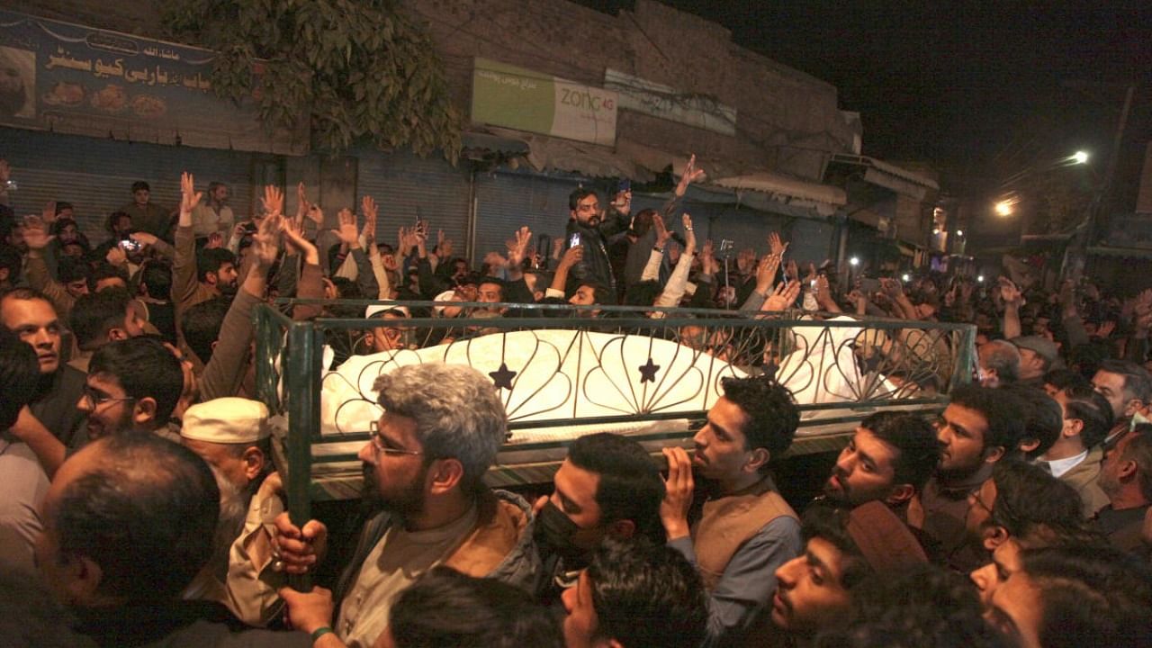 Shiite Muslims shout religious slogans while they attend a funeral for the victims of a suicide bombing in a Shiite Muslim mosque in Peshawar, Pakistan. Credit: AFP Photo