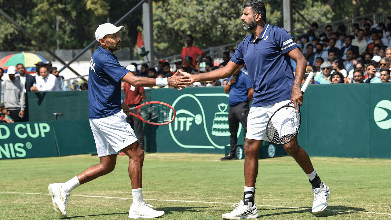 India's Rohan Bopanna and Divij Sharan shake hands celebrating a point against Denmark's Frederik Nielsen and Johannes Ingildsen during their doubles Davis Cup World Group 1 playoff match. Credit: PTI Photo
