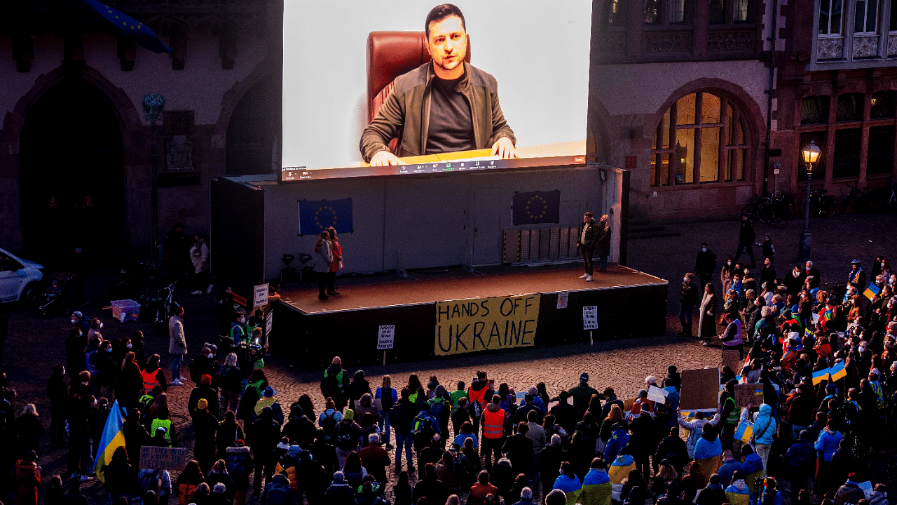 Ukrainian President Volodymyr Zelenskyy delivers a video message to the people joining a rally on the Remember square in Frankfurt. Credit: AP Photo