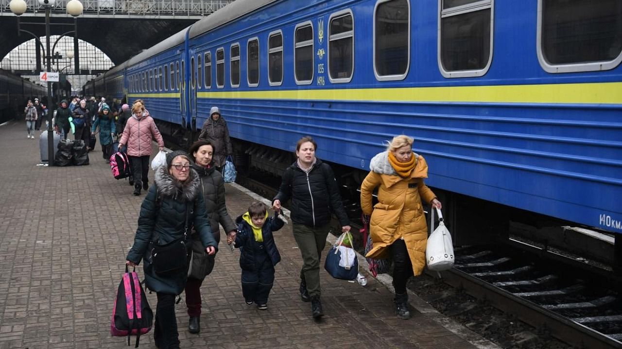 Evacuees rush to board a train to Poland, at the Lviv train station, western Ukraine. Credit: AFP Photo