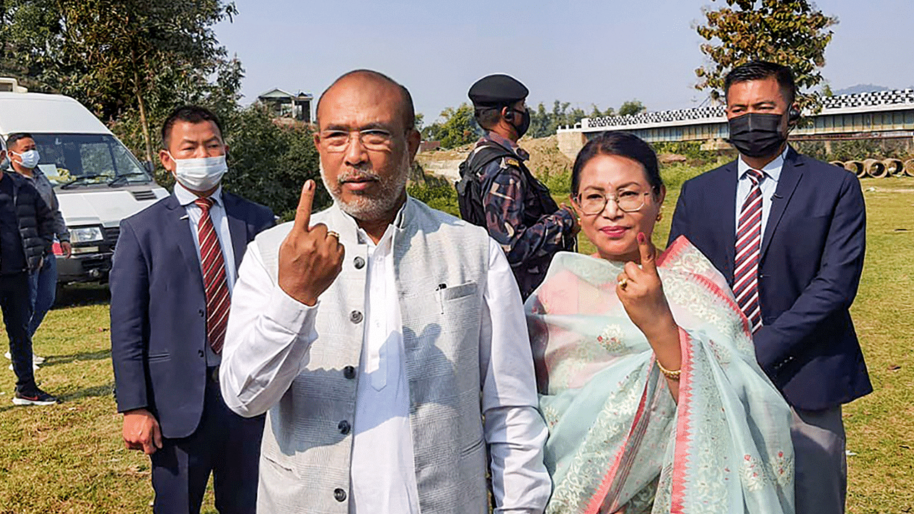 Manipur Chief Minister N. Biren Singh and his wife Hiyainu Devi show their fingers marked with indelible ink after casting their vote for the first phase of Manipur Assembly Elections. Credit: PTI Photo