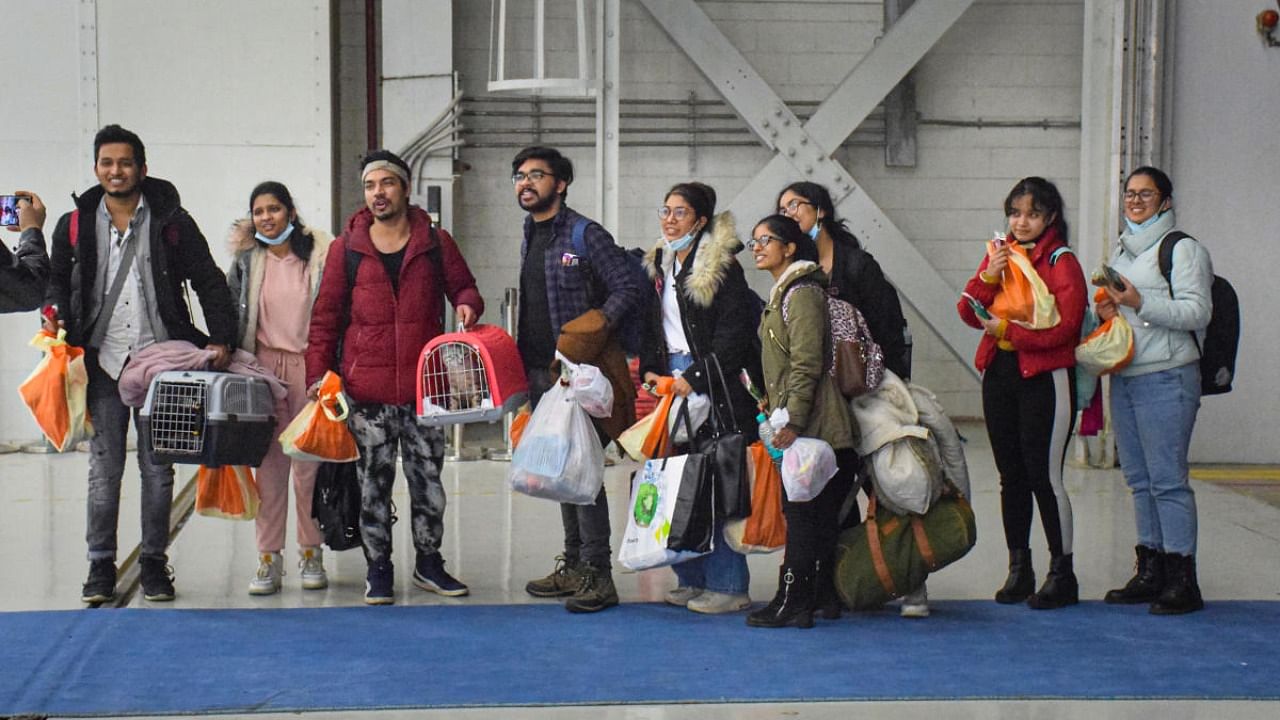 Indian nationals, evacuated from crisis-hit Ukraine, pose for photos upon their arrival at the Hindon Air Force Station. Credit: PTI Photo