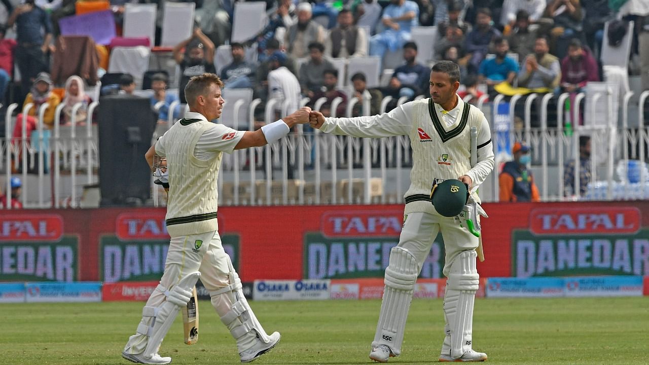 Australia's David Warner (L) and teammate Usman Khawaja. Credit: AFP Photo