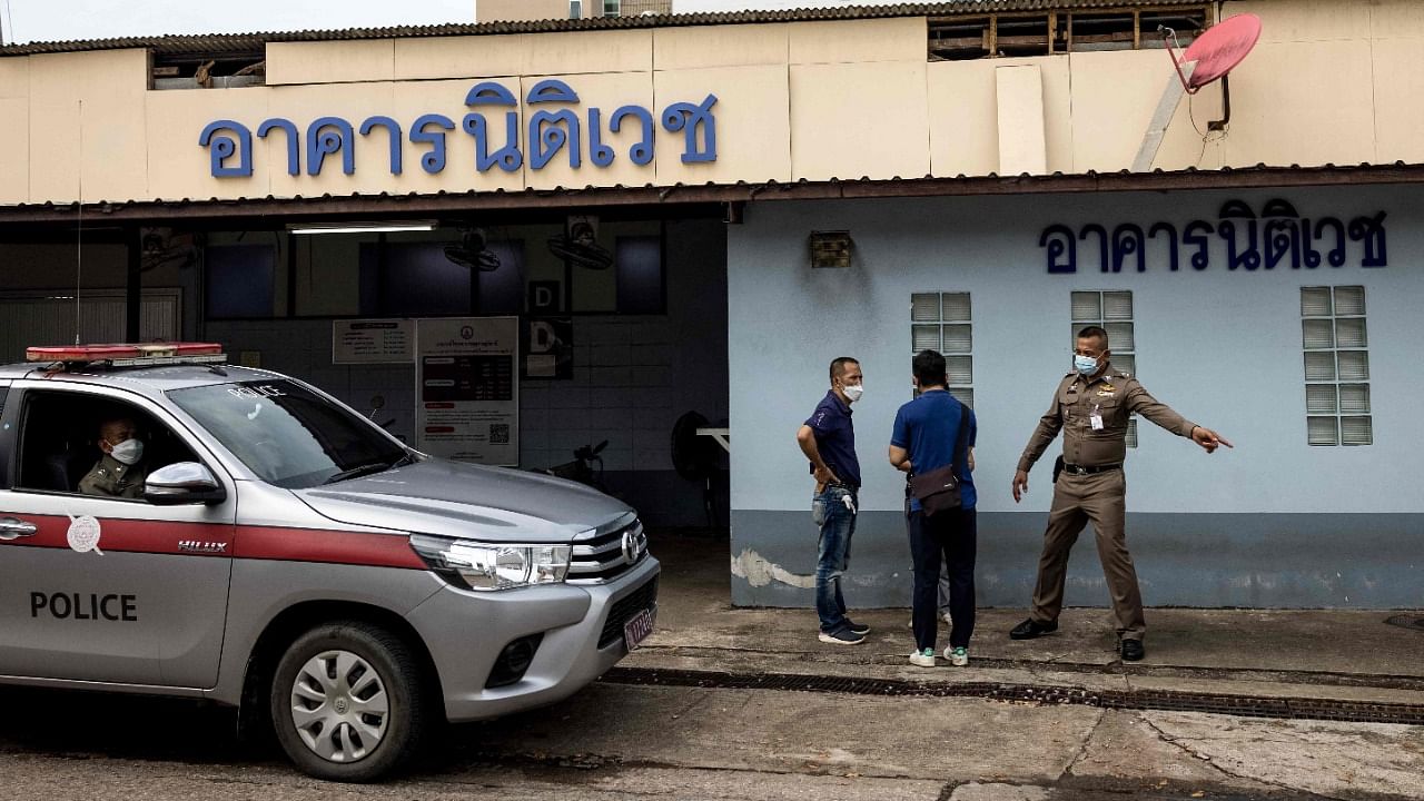 Police officers talk outside the Surat Thani Hospital morgue and forensics lab in Thailand's Surat Thani province as Thai authorities prepare to conduct an autopsy on the body of Australian cricket player Shane Warne. Credit: AFP Photo