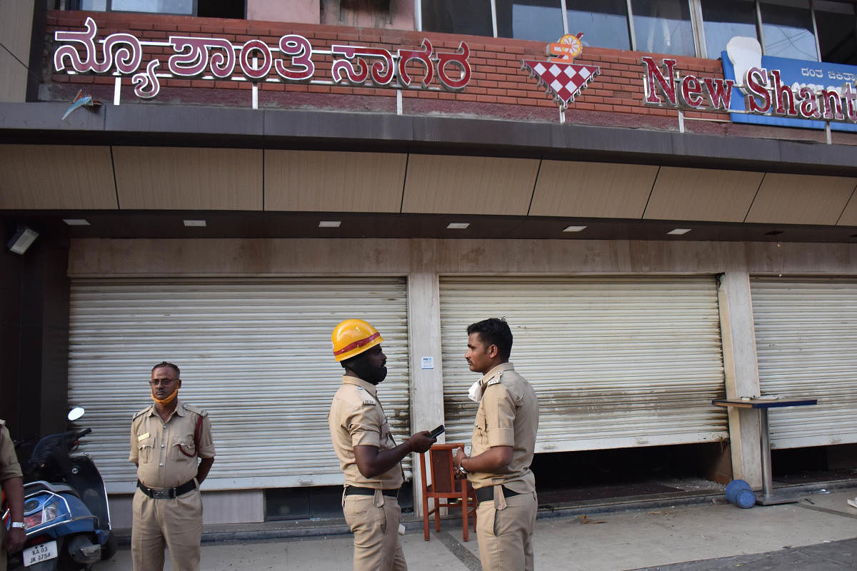 Police inspect the site of the blast in a hotel on CMH Road at Indiranagar on Saturday. Credit: DH Photo