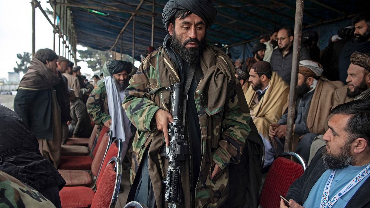 Taliban fighters walk through the spectators stand during a football match in Kabul. Credit: AFP Photo