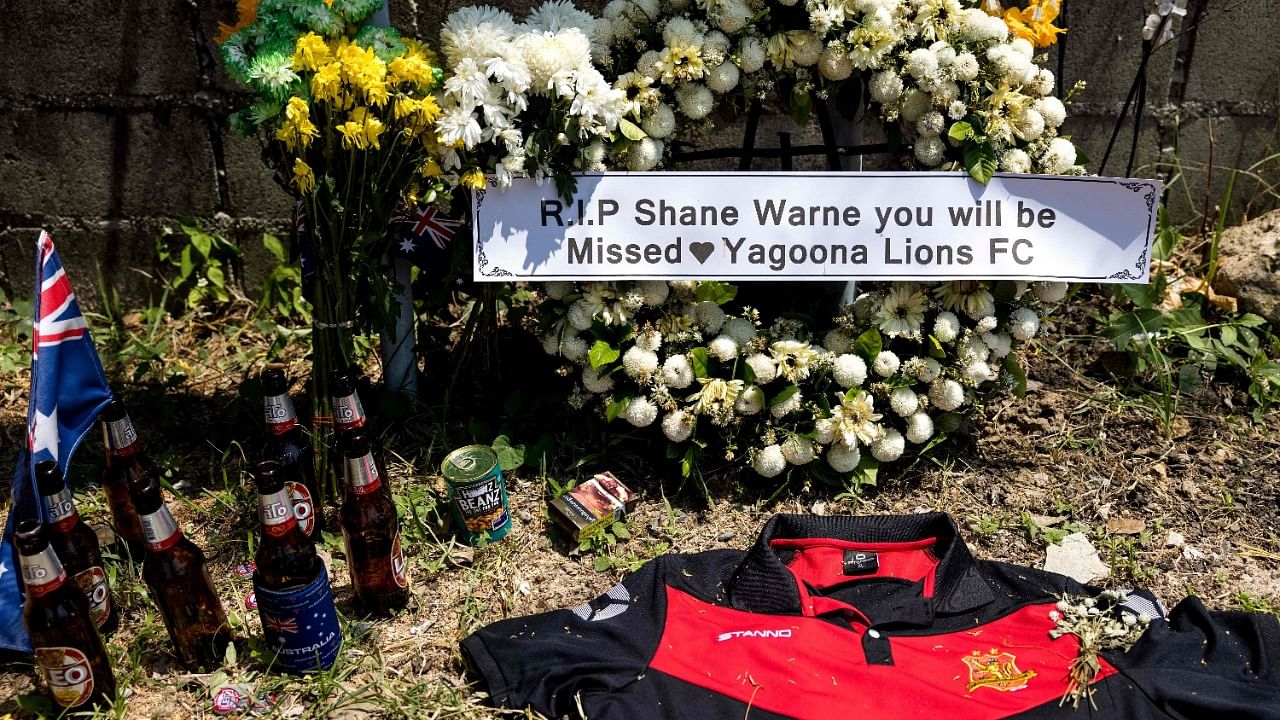 Tributes to the late Australian cricket player Shane Warne are seen outside Samujana Villas on Thailand's Koh Samui on March 7, 2022, after the sportsman died of a suspected heart attack on March 4 after being found unresponsive in the luxury resort. Credit: AFP Photo
