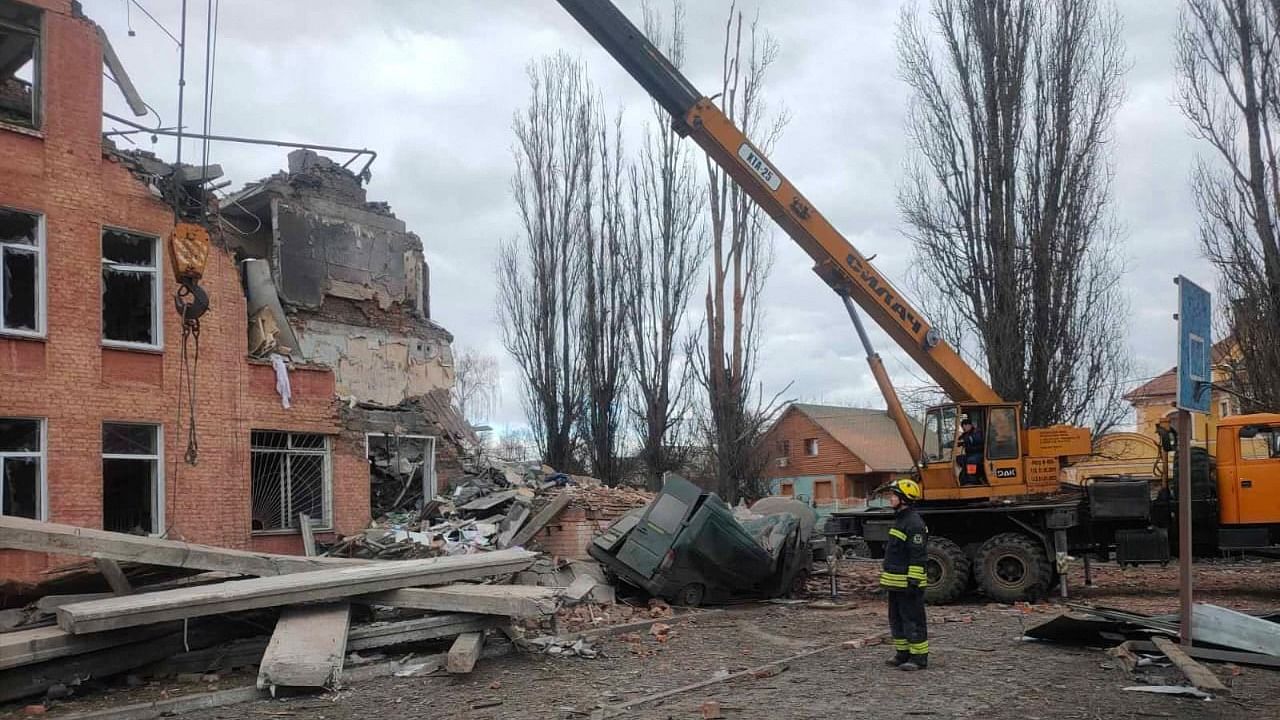 This handout picture taken and released by the Ukrainian State Emergency Service on March 7, 2022, shows rescuers dismantling the rubble of a destroyed school after Russian troops shelled the city of Chernihiv. Credit: AFP Photo