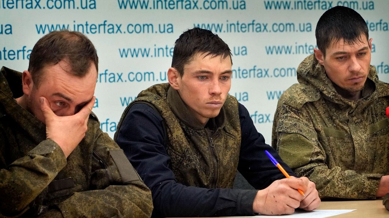 Captured Russian soldiers answer media questions at a press conference in the Interfax news agency in Kyiv, Ukraine. Credit: AP/PTI Photo